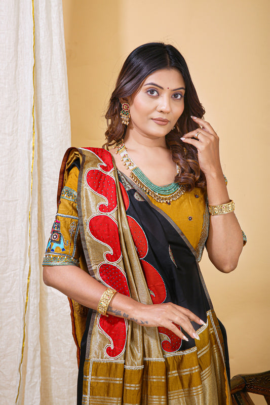 Woman wearing a traditional saree with a red and gold pattern against a beige background